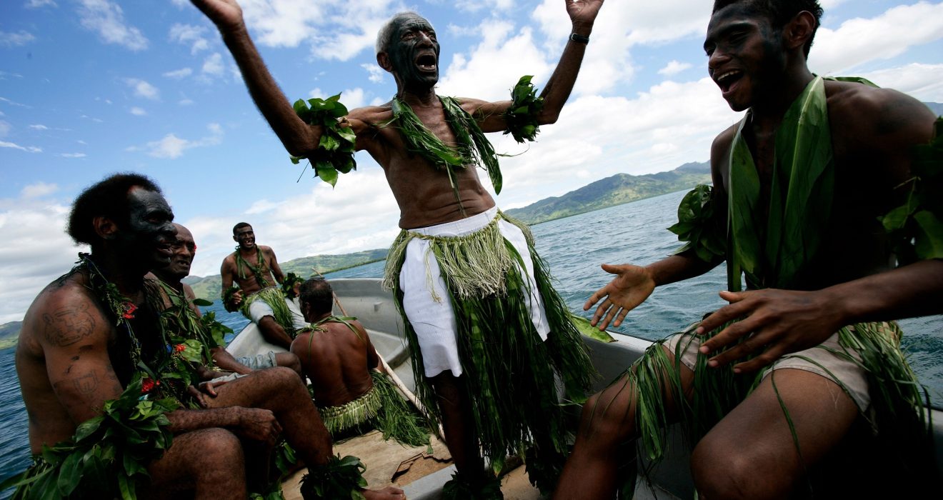 Local fishermen, in traditional Fijian dress, singing traditional songs and going out by boat to mark the creation of a new Marine Protected Area © Brent Stirton
